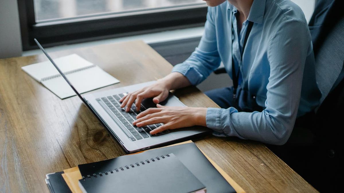 woman typing on laptop