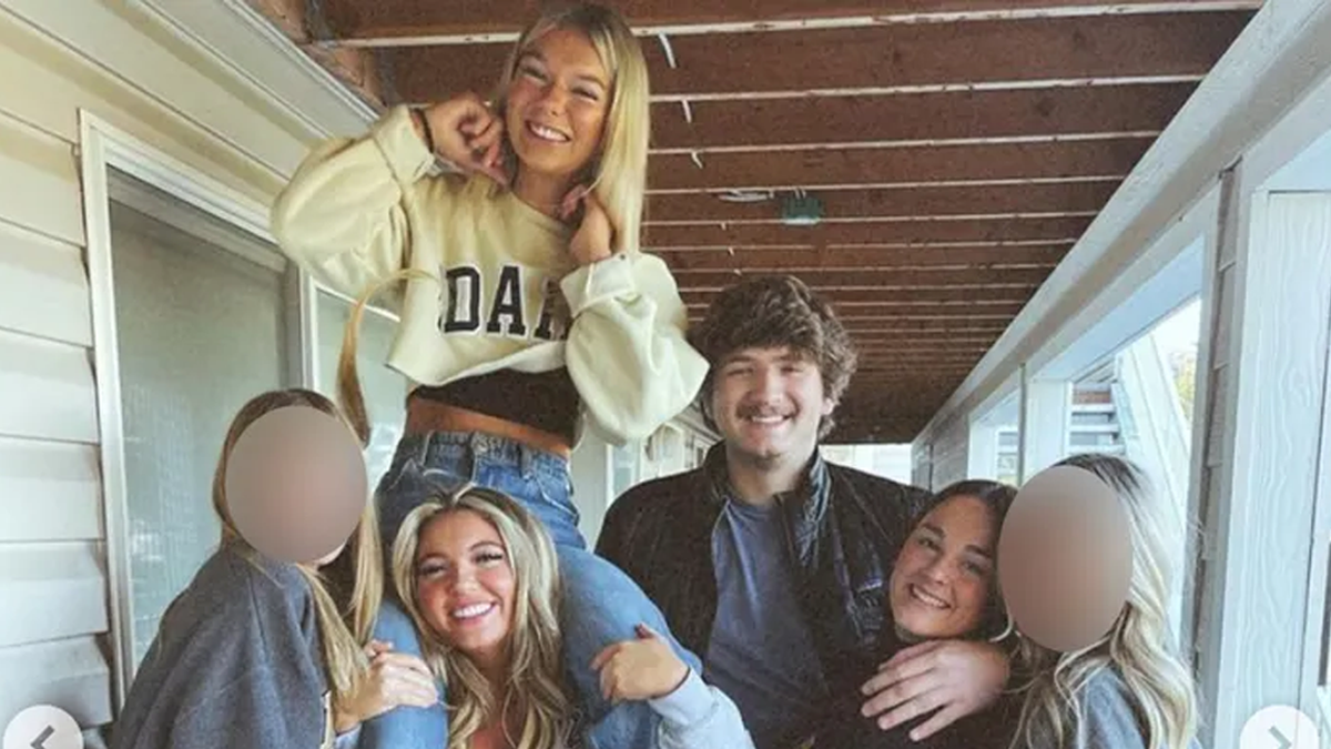 Maddie Mogen its on Kaylee Goncalves' shoulders as they smile next to Ethan Chapin, Xana Kernodle and two other friends whose faces are blurred out in the idaho students final photo together