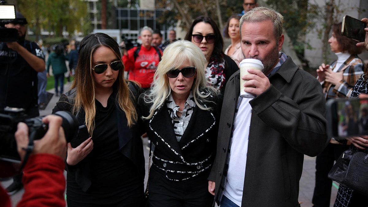 Tammi Menendez, Erik Menendez' wife, and Erik Menendez' stepdaughter walk near the Van Nuys Courthouse