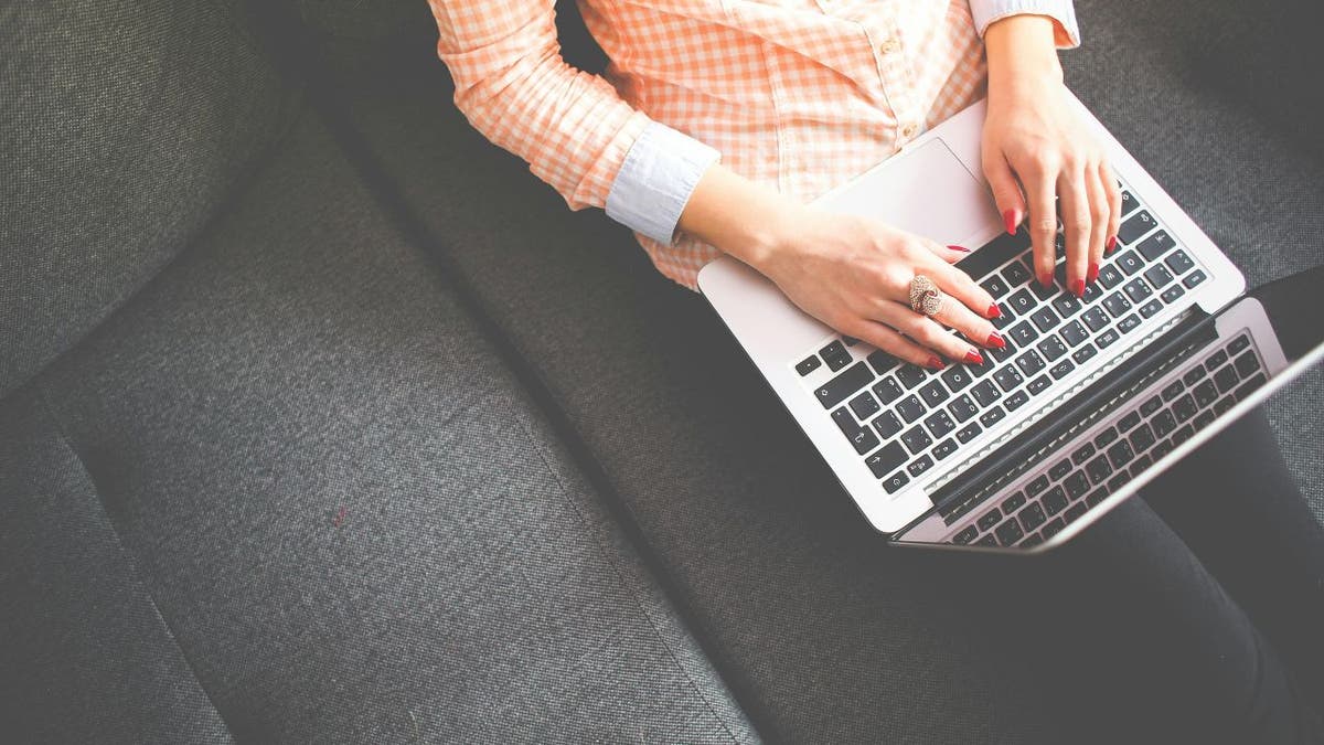 woman typing on laptop