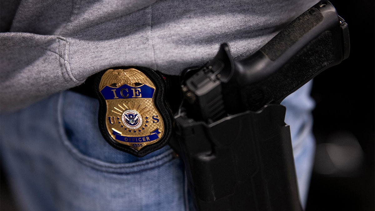 ICE agent badge and gun