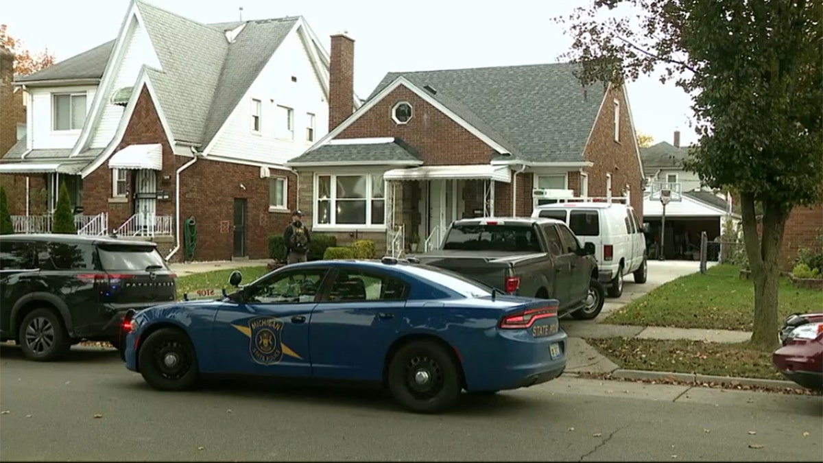 A house with police cars parked in front of it