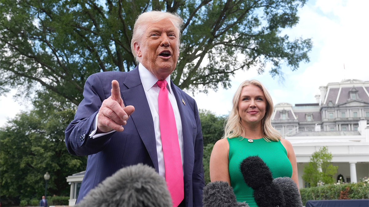 President Donald Trump, accompanied by White House press secretary Karoline Leavitt