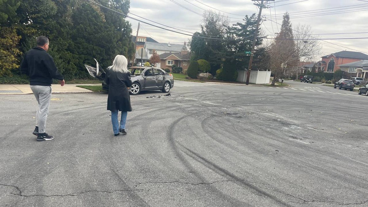 Skid marks on a road and a torched vehicle in New York City