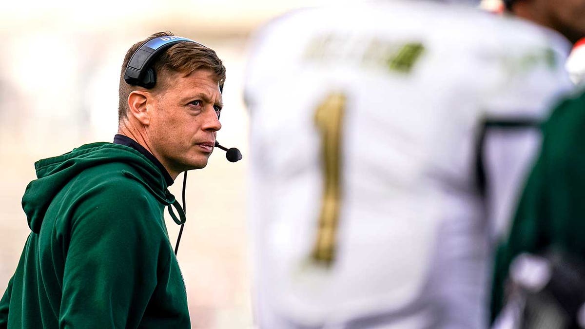 Alex Mortensen watches from the sideline