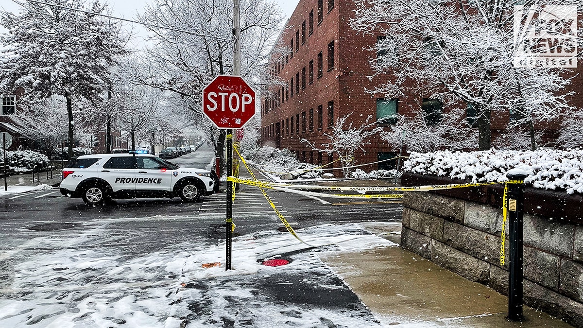 police vehicle and police tape on campus