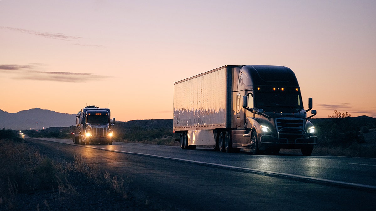 A cargo truck driving down a remote highway