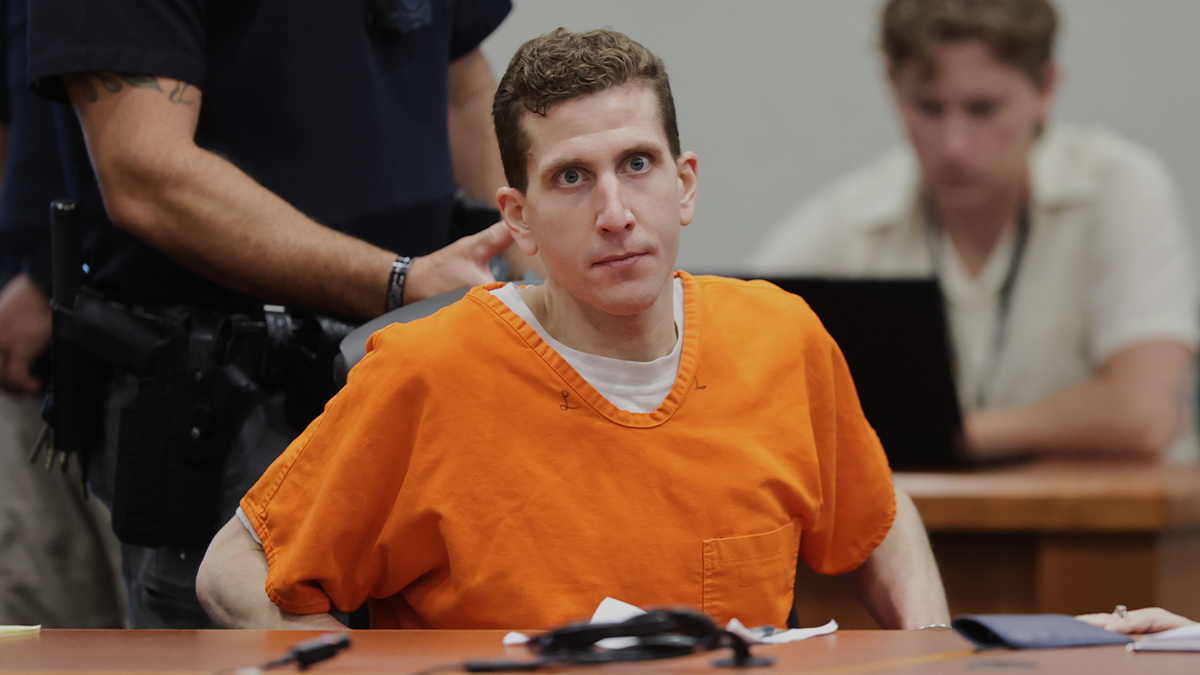 Bryan Kohberger adjusts his seat at the Ada County Courthouse, wearing an orange jail jumpsuit over a white T-shirt