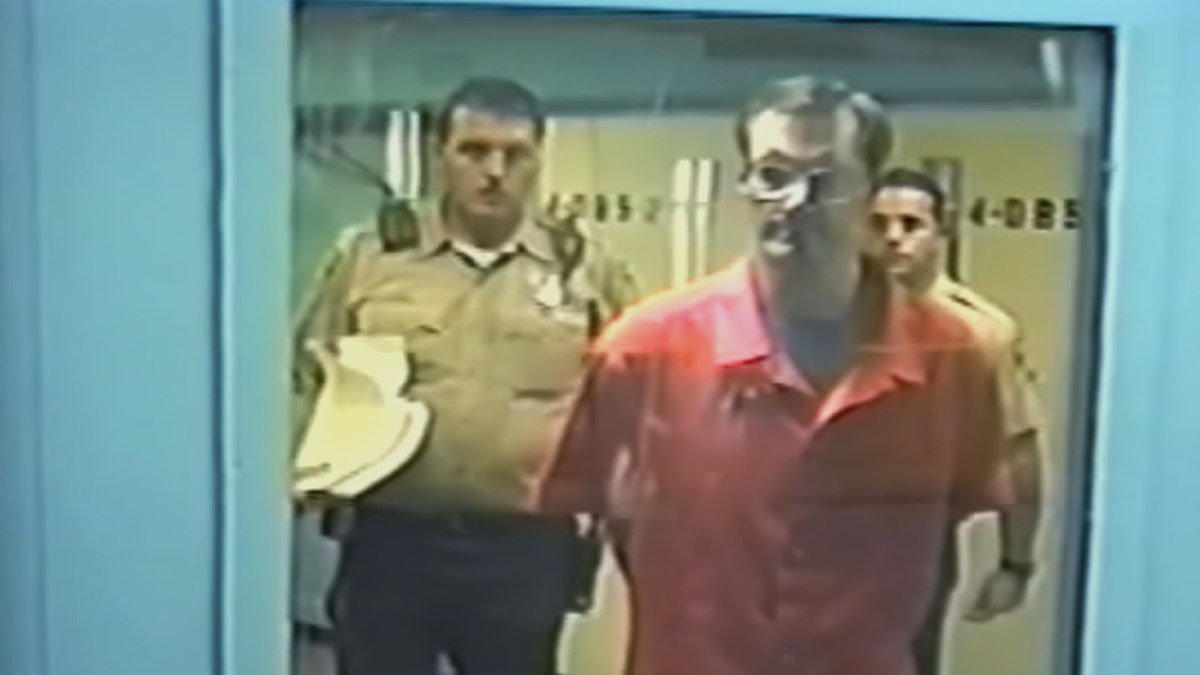 Doug Gretzler in an orange jumpsuit.