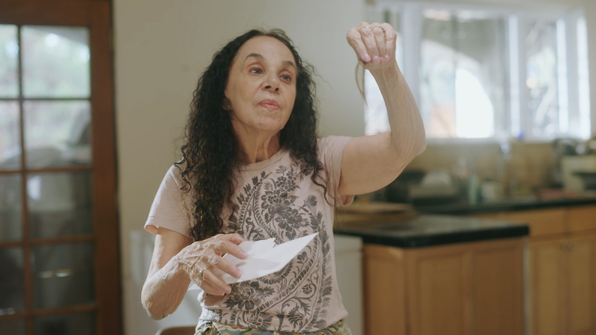 Laura Greenberg holding up a lock of hair.