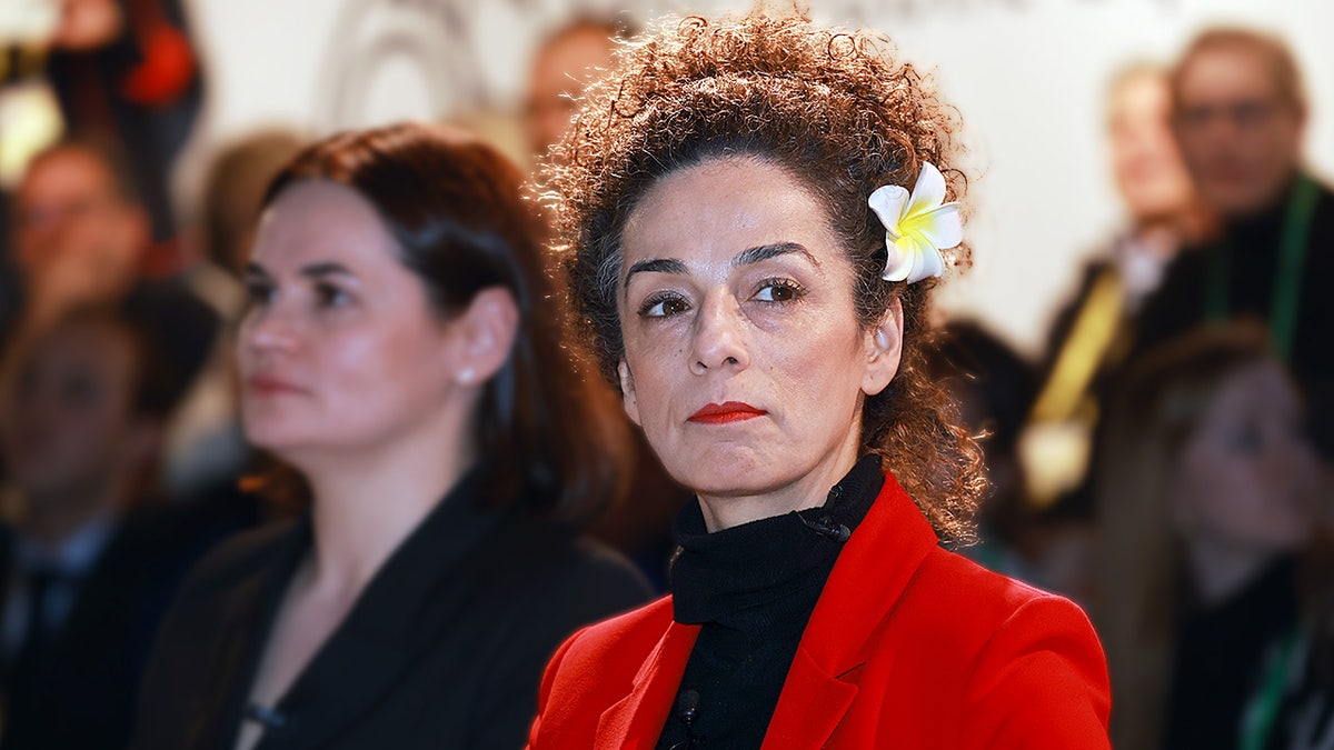 Iranian activist Masih Alinejad sits onstage during a panel discussion at an international security conference.