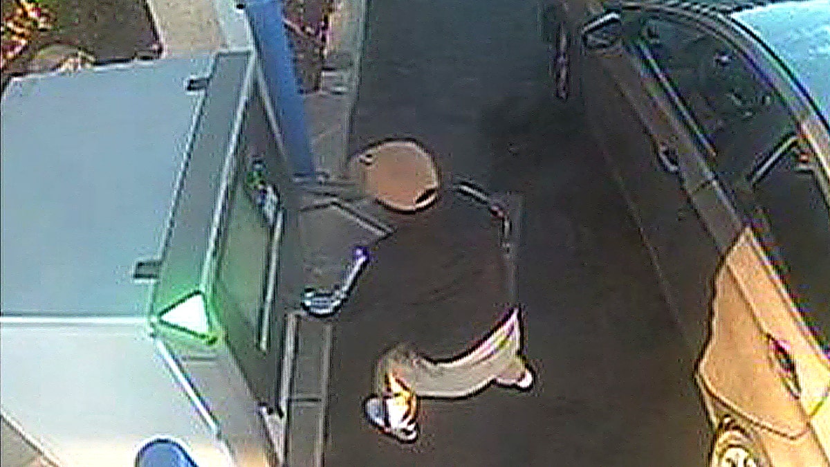 Suspect stands near ATM machine