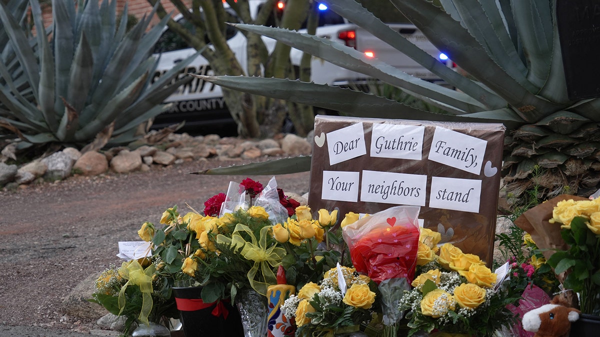 Nancy Guthrie's home with a growing vigil of flowers and candles in the morning light.