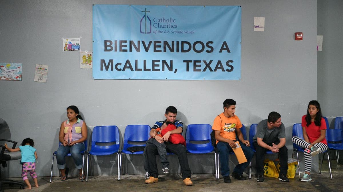 Migrants sitting at a shelter in Texas