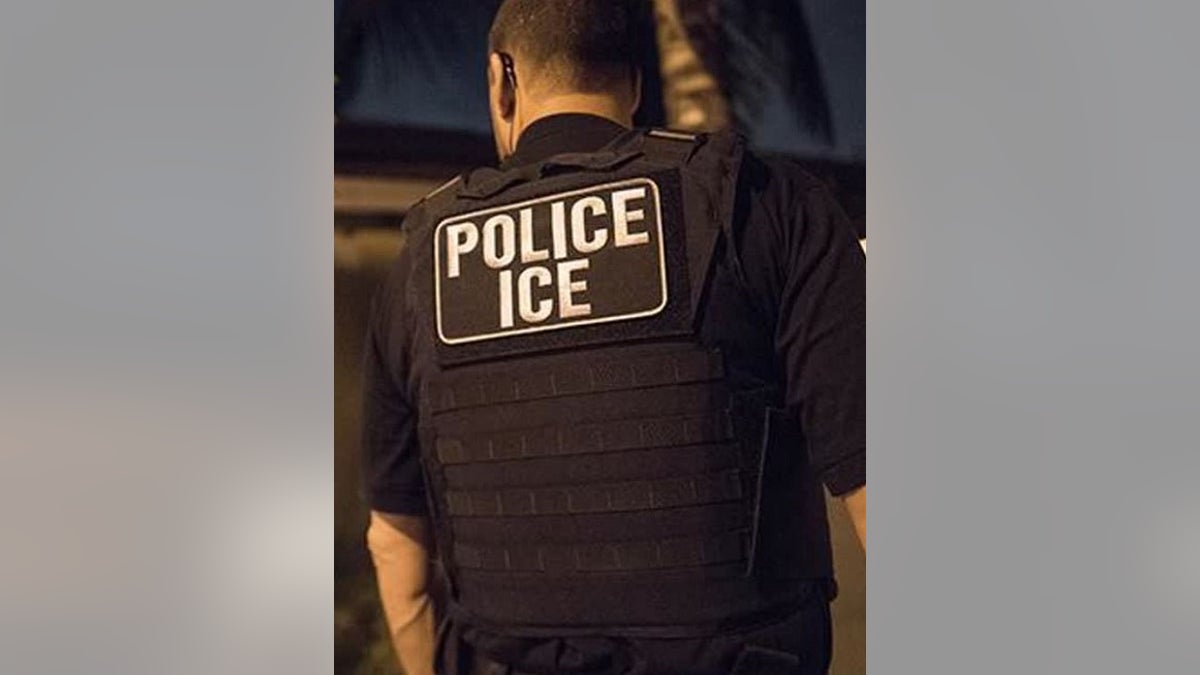 ICE agent seen from behind