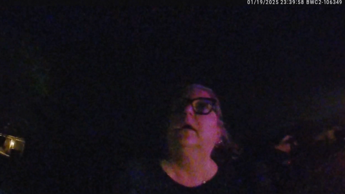 Karly Anderson talks to police officer