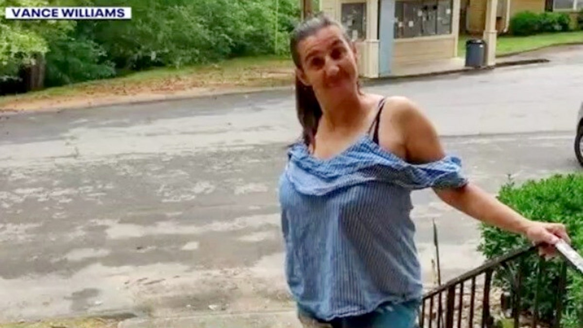 Camillia Williams smiling while standing on stairs outside