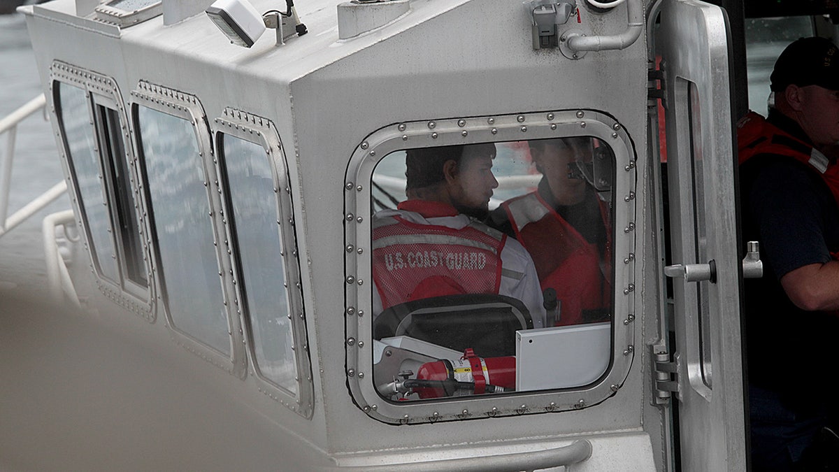 The back of Nathan Carman being seen inside a boat.