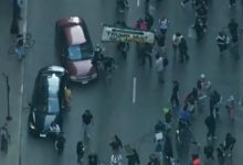 Car drives through anti-ICE protesters as Chicago joins nationwide anti-ICE unrest amid Trump crackdown