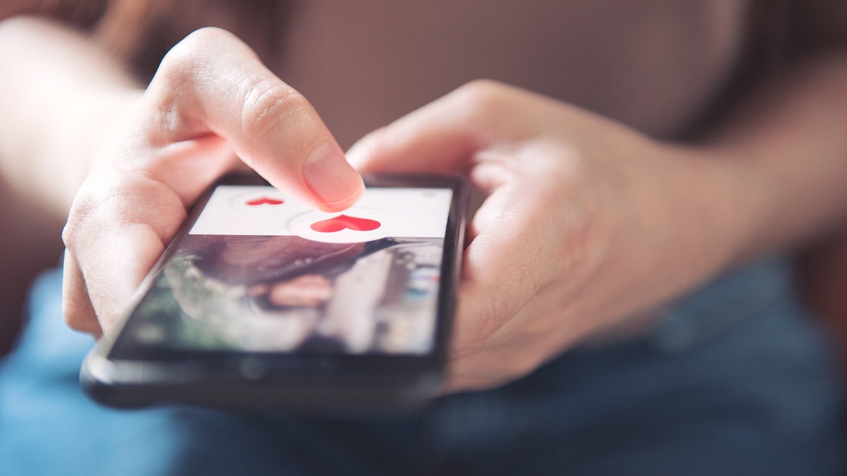 A woman swiping through dating apps