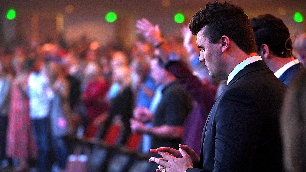 Turning Point USA founder Charlie Kirk prays as he attends Freedom Night In America at Dream City Church on Oct. 5, 2022 in Phoenix, Arizona.