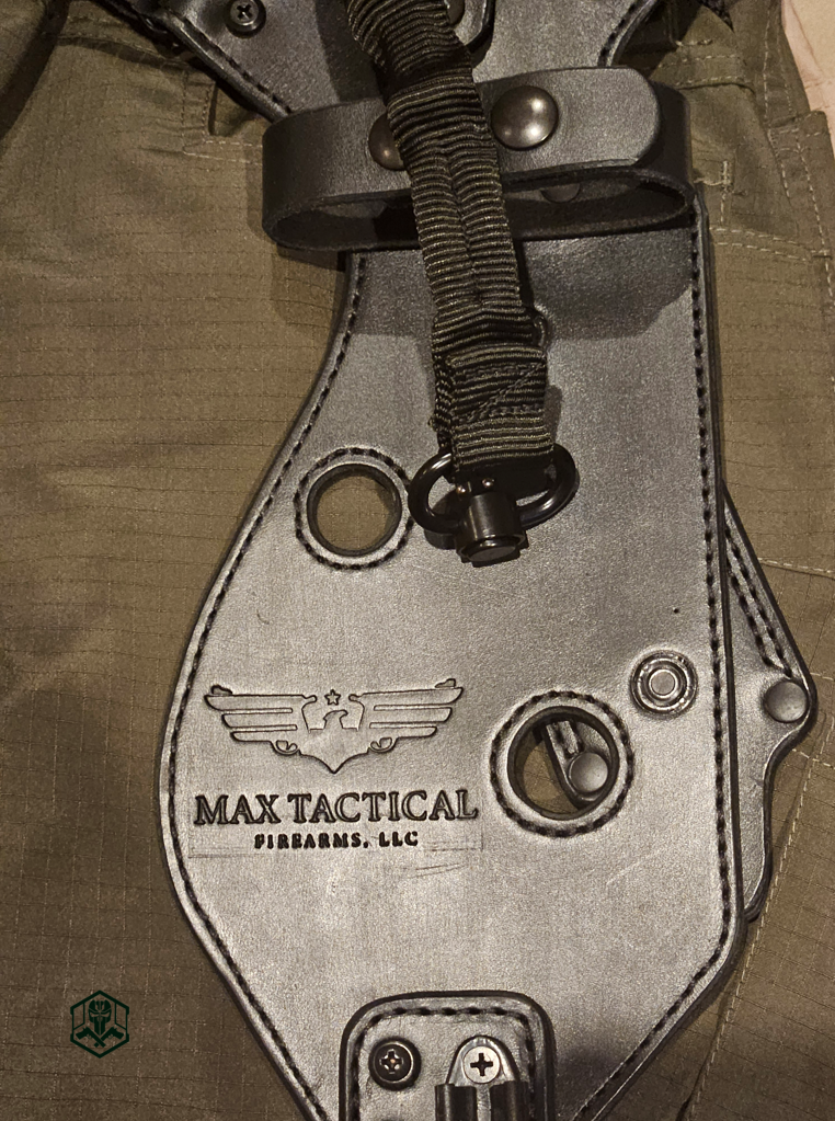 custom leather holster panel showing precision stitching, with snap-button retention points, a tactical sling loop, and embossed logo.