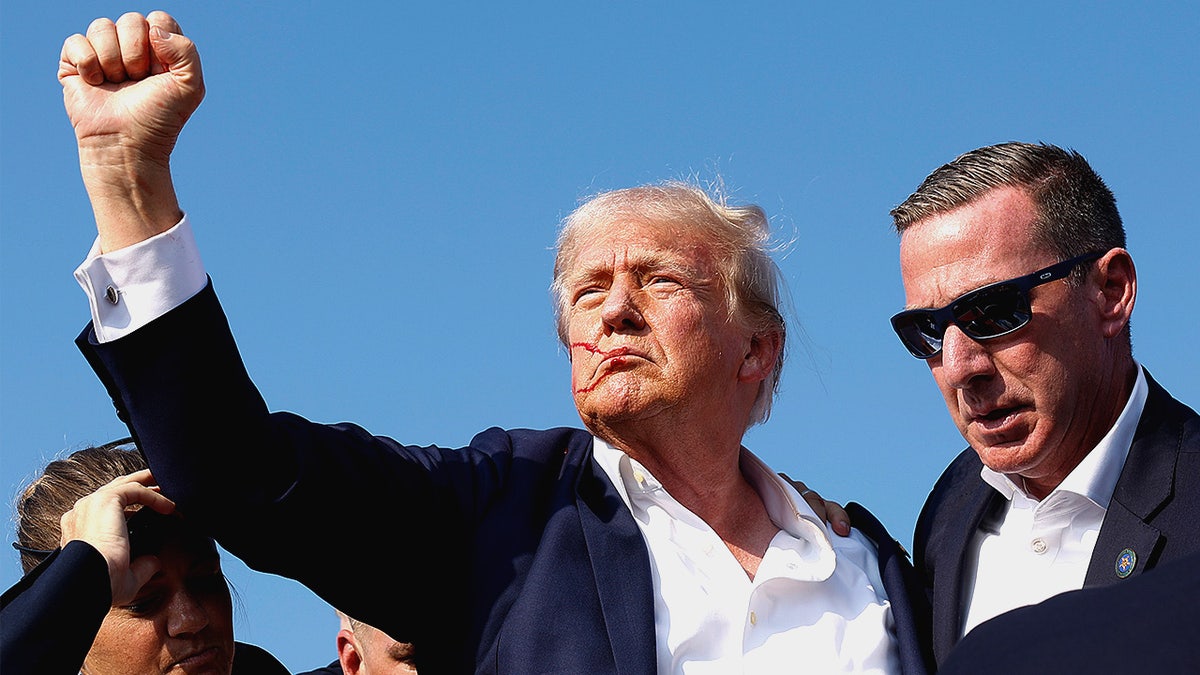 President Donald Trump raises his fist after being shot at a campaign event in Butler, Pennsylvania.