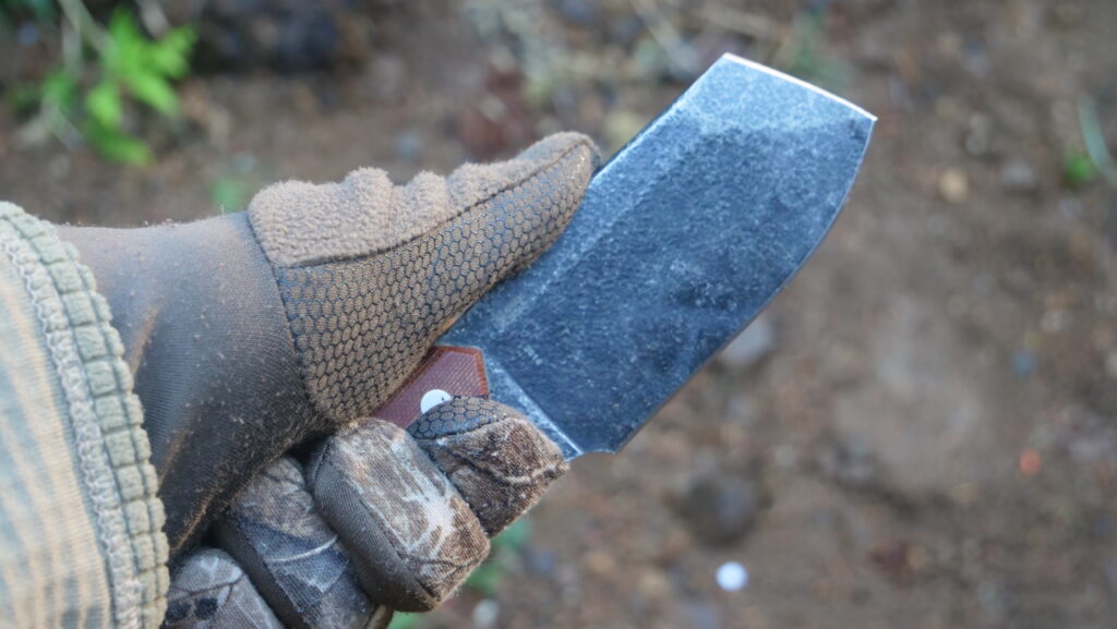 Close-up of CRKT Razel Nax 1075 carbon steel chisel tip