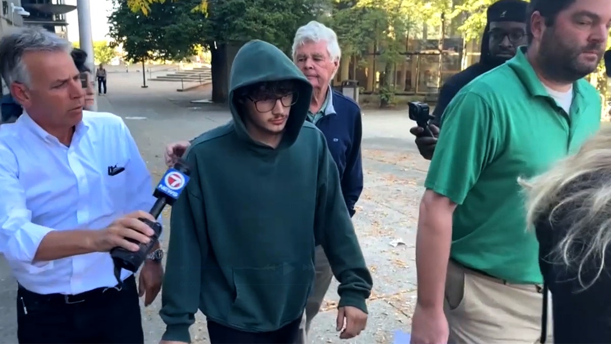 Julian Bowers, 18, walks out of court