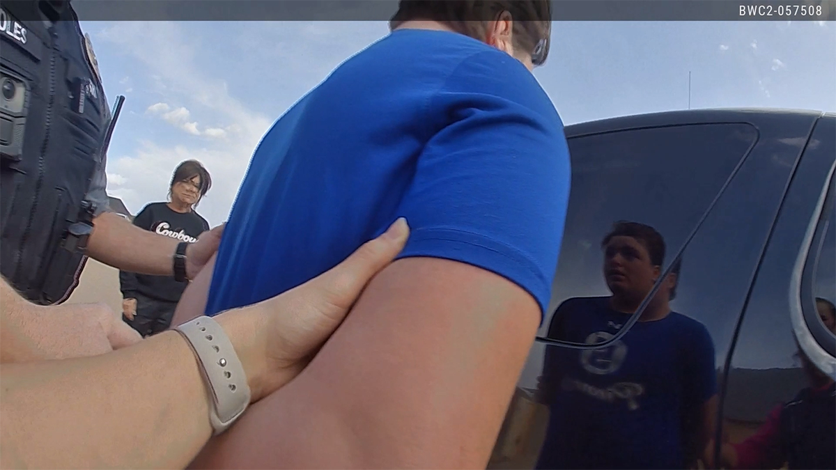 Jesse Butler taken by police in handcuffs