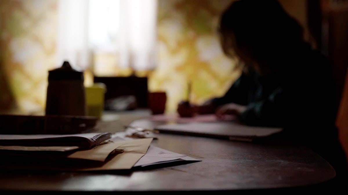 Handwritten letters by Ted Bundy on a desk.