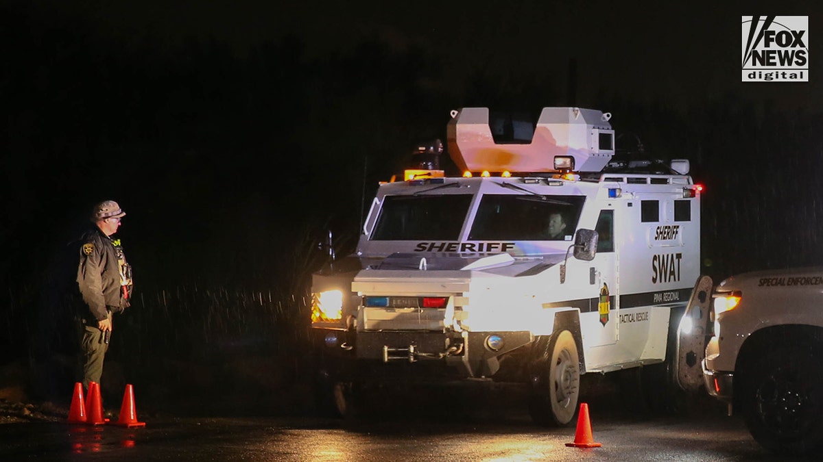 A Pima County Sheriff's deputy standing during a law enforcement operation at an intersection in Tucson, Arizon