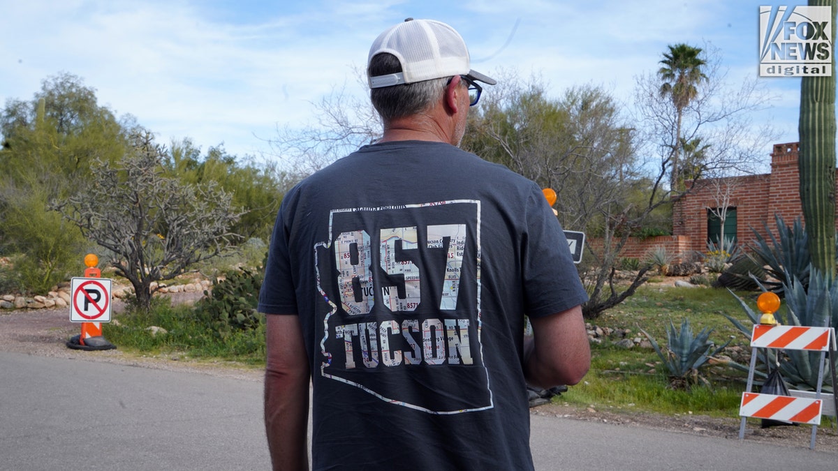 A man wearing a hat and shirt with 857 Tucson on it.